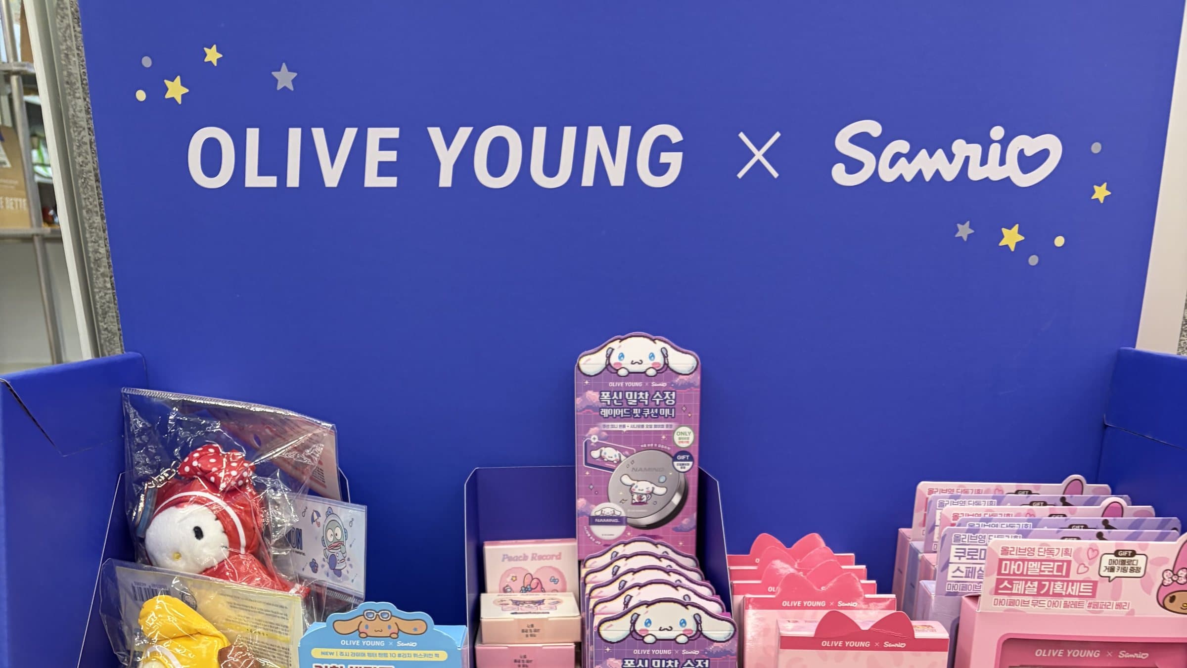 Olive Young x Sanrio endcap with Cinnamoroll, Hello Kitty and My Melody beauty sets on the top shelf