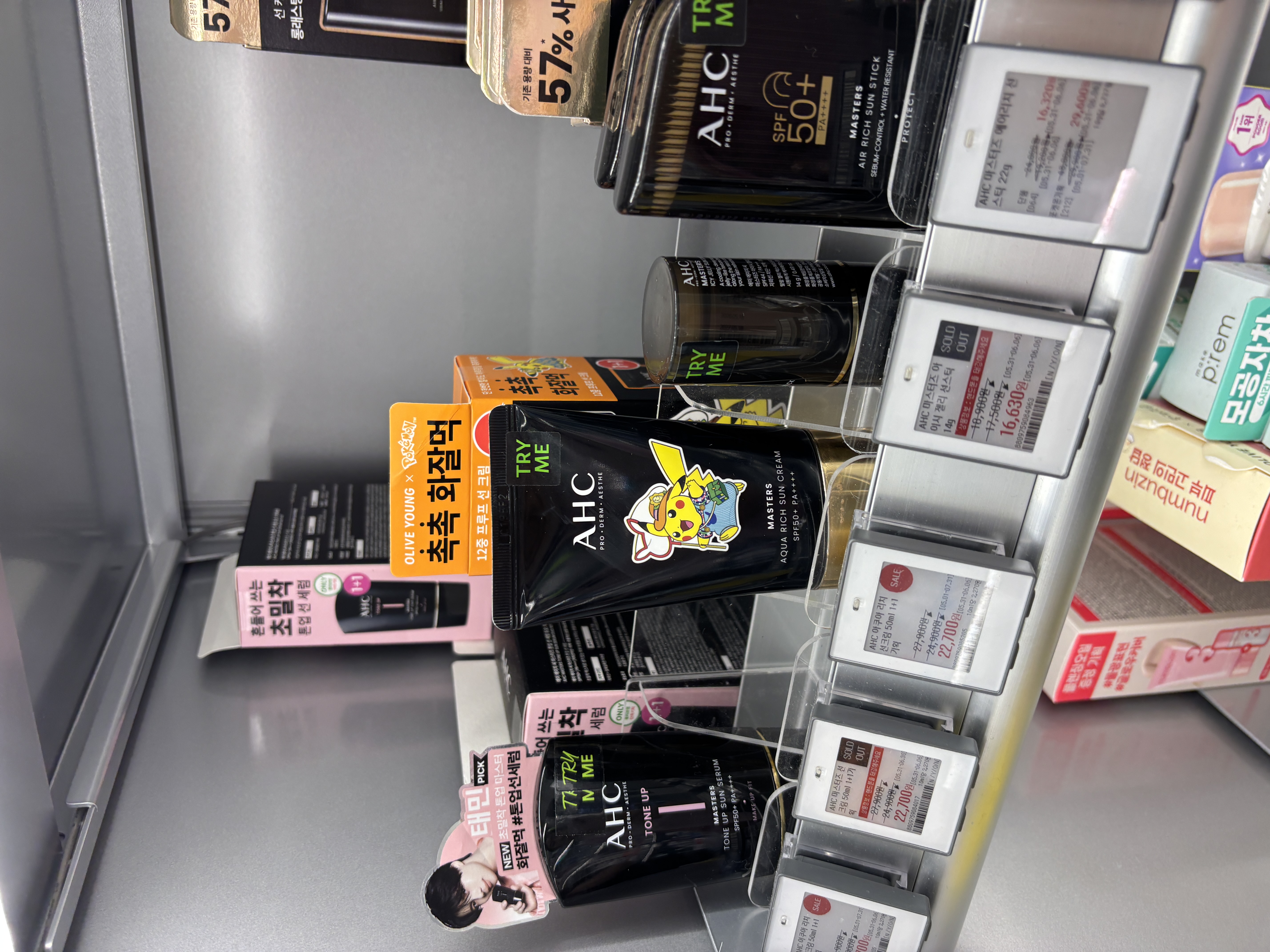 AHC Masters sun products with Pokemon collaboration Pikachu packaging at Olive Young showing Aqua Rich Sun Cream, Air Rich Sun Stick, and Tone Up Sun Serum all SPF 50 plus