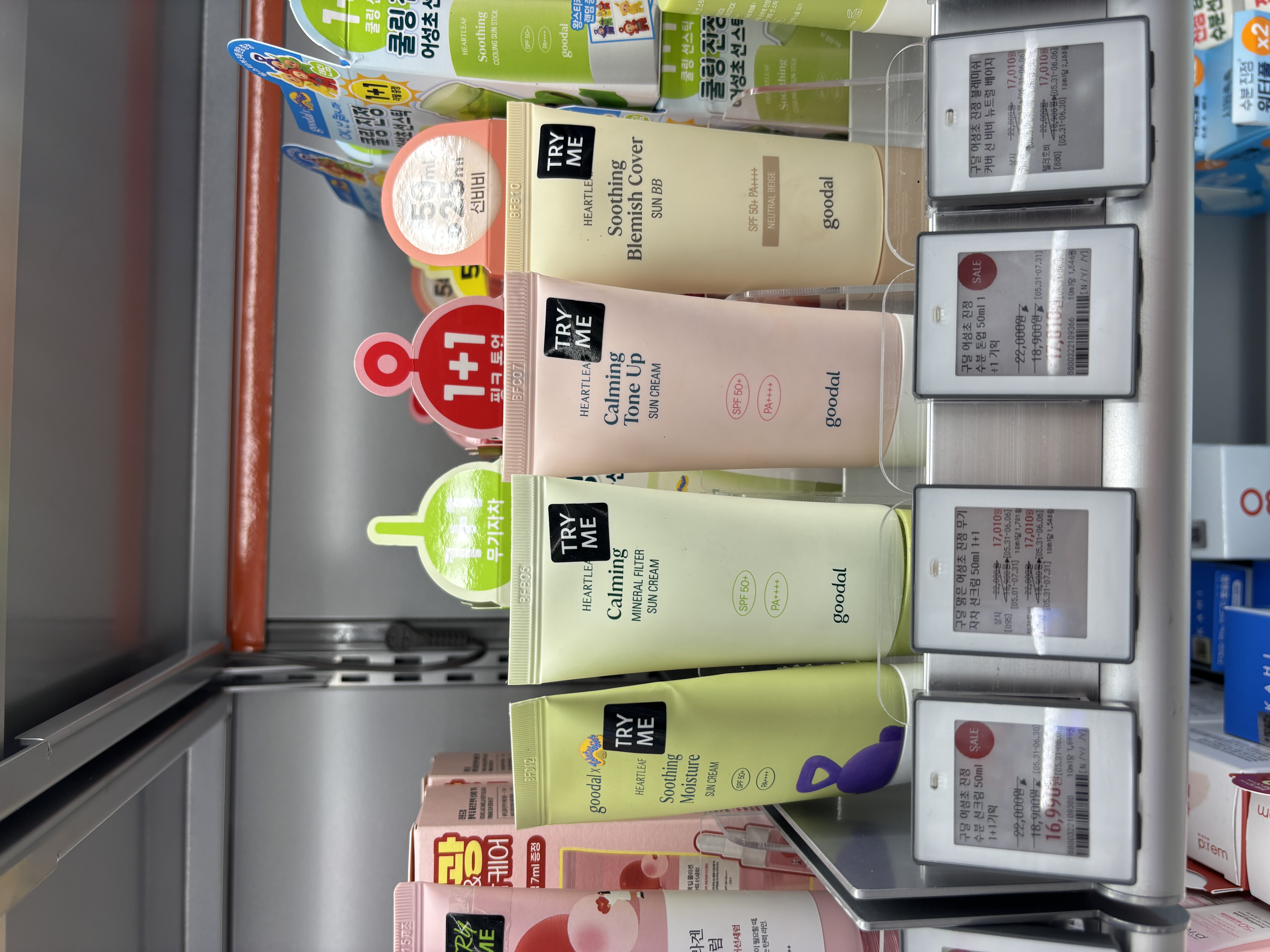 Goodal Heartleaf Calming sun products on Olive Young shelf showing Blemish Cover Sun BB, Calming Tone Up, Calming Mineral Filter, and Soothing Moisture variants with price tags