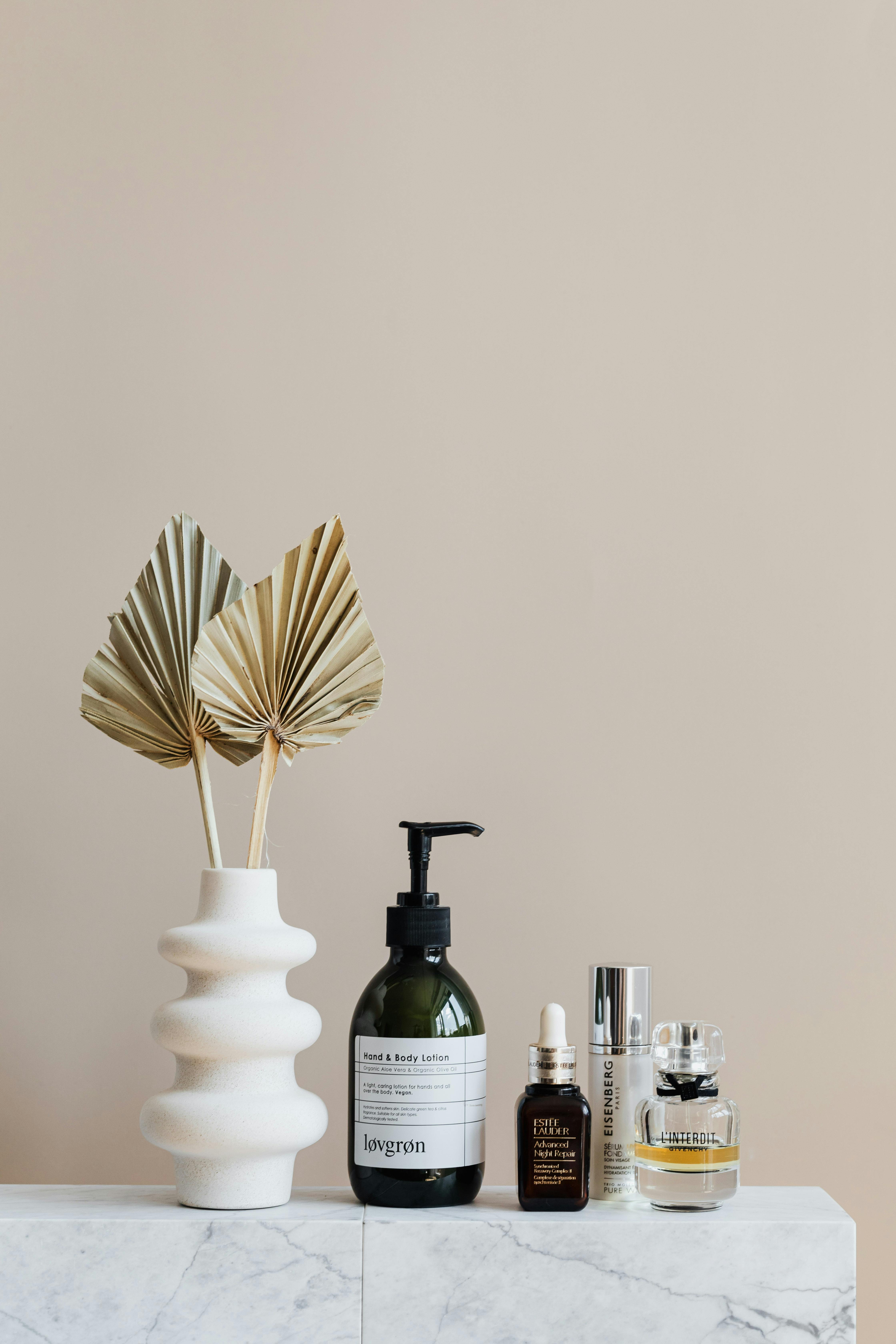 Bottles and a soft towel laid out for a stripped-back sensitive skin routine focused on gentle cleansing and barrier repair